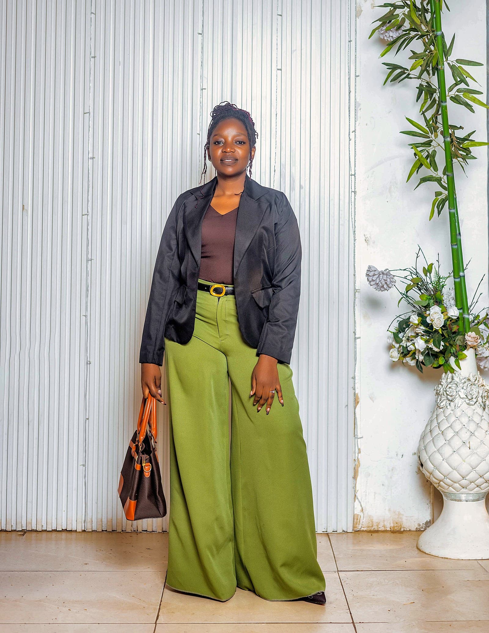 Black blazer over olive wide-leg trousers